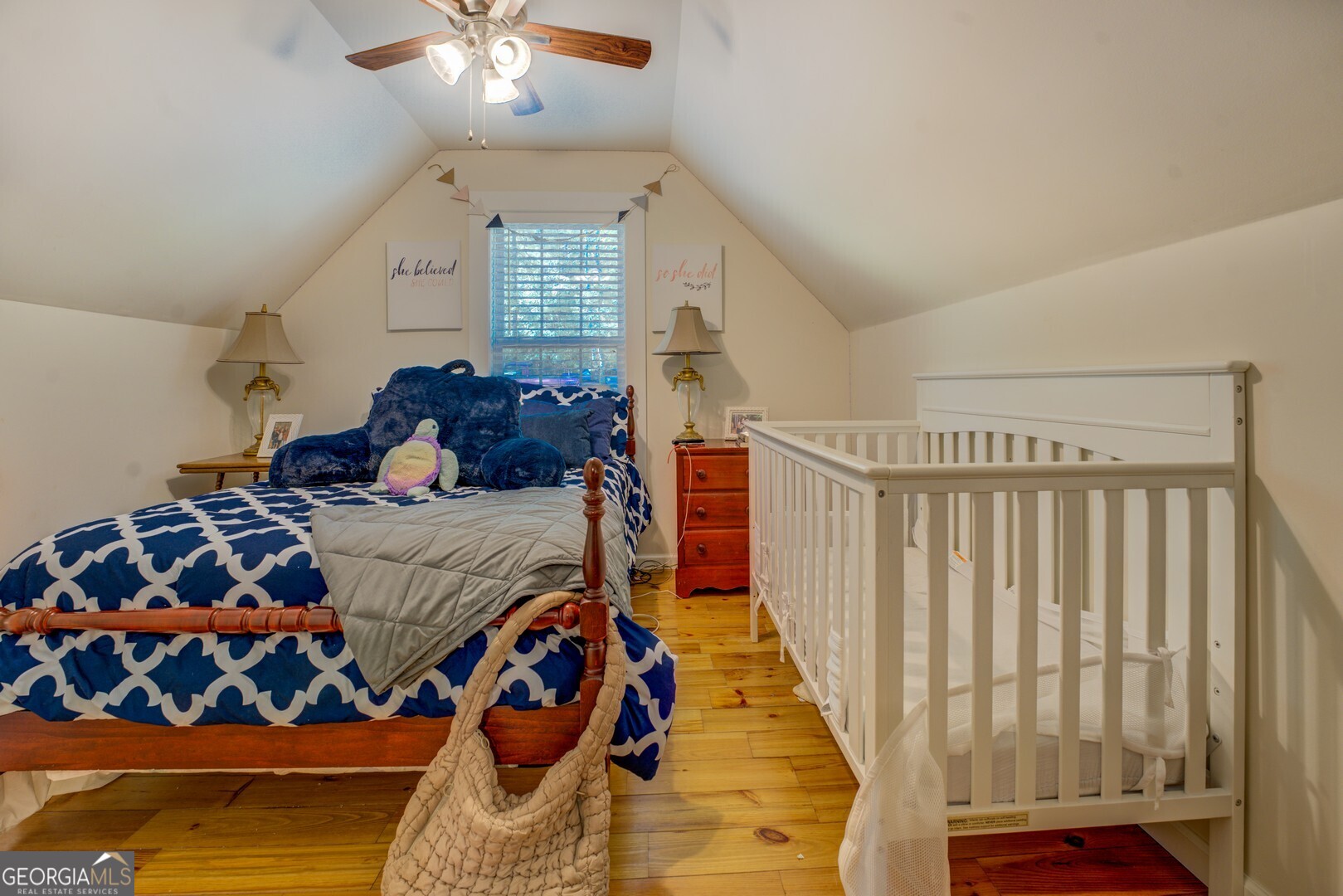 734 Raven Road Monticello, GA 31064 - Photo 53 of 81 a bedroom with a large bed and a chandelier