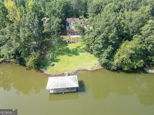 a view of a house with a yard and pathway