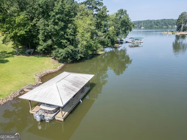 a view of a house with a yard and tree s