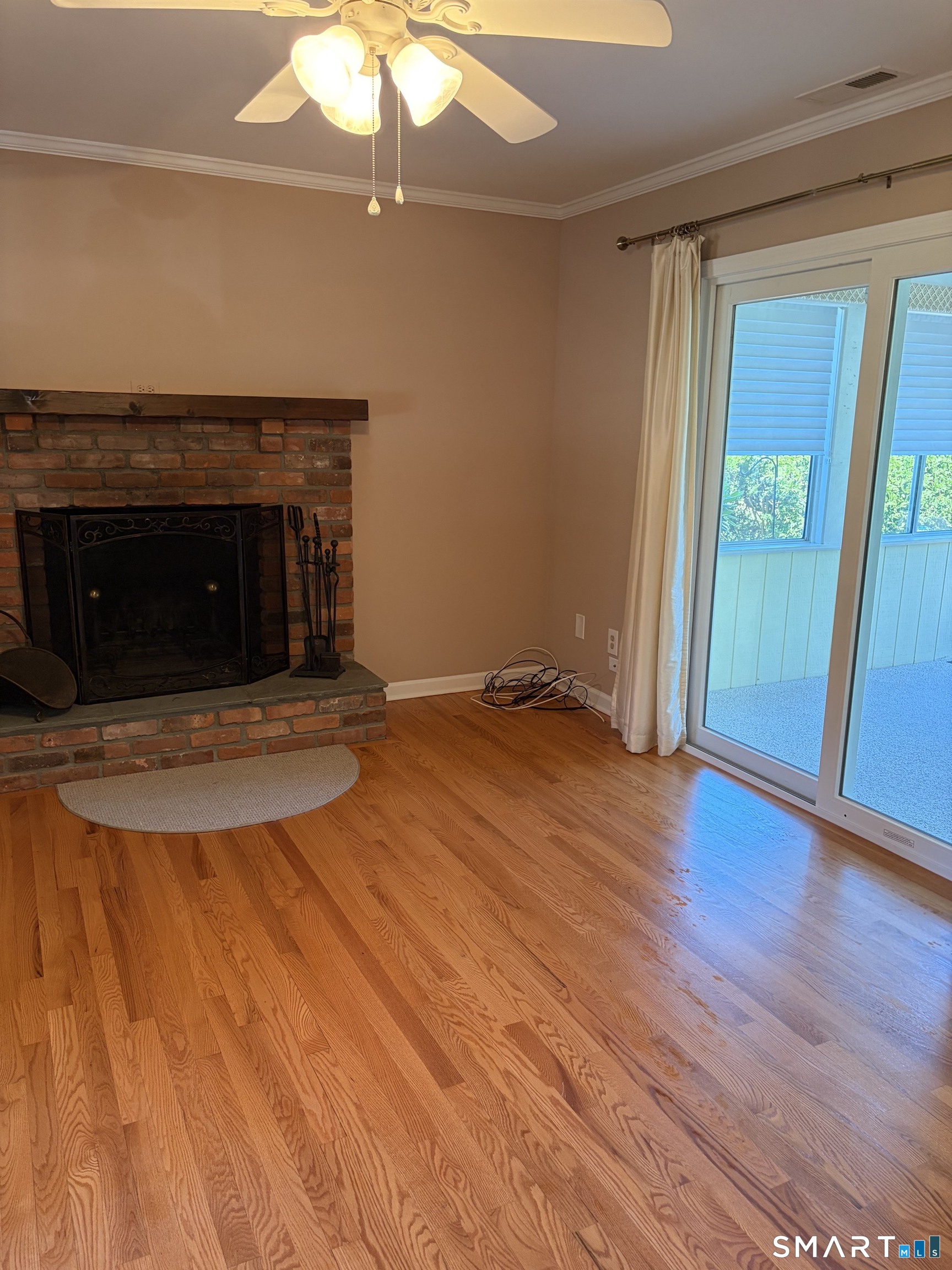28 Downing Way, Unit 28 Madison, CT 06443 - Photo 9 of 11 Fireplace and sliders to three season porch