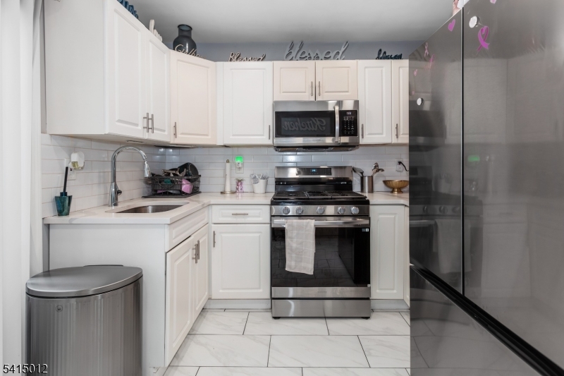 40 Bennington Square Hackettstown, NJ 07840 - Photo 9 of 23 a kitchen with stainless steel appliances a white stove top oven and cabinets
