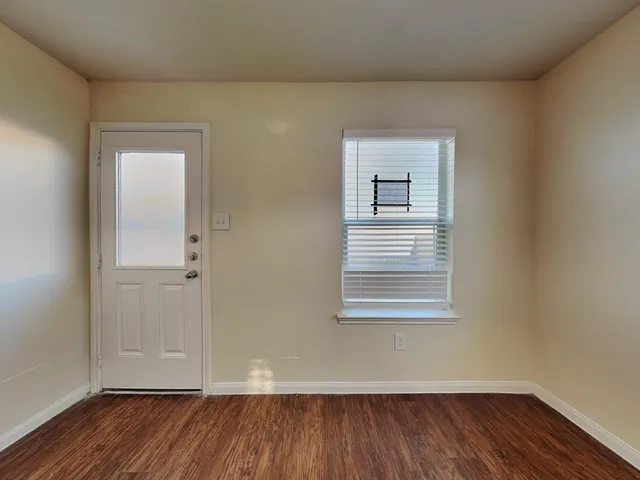 a view of a kitchen cabinets and wooden floor