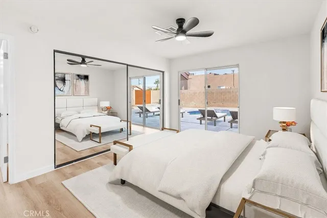 a bedroom with a bed a table and painting on the wall