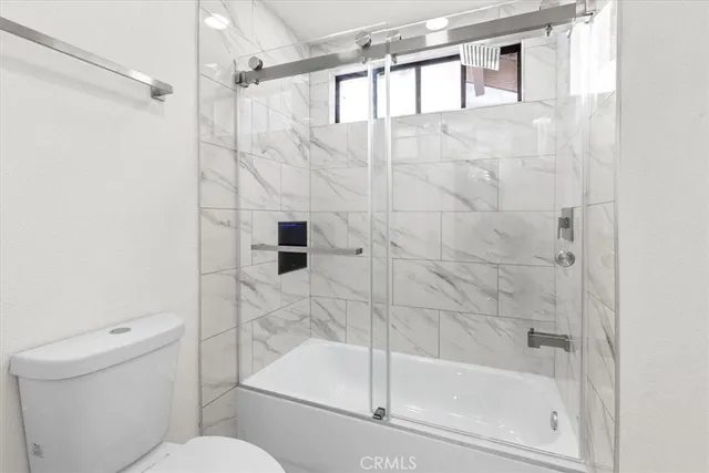 a bathroom with a shower and toilet