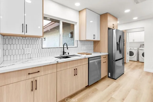 a kitchen with a sink cabinets and refrigerator