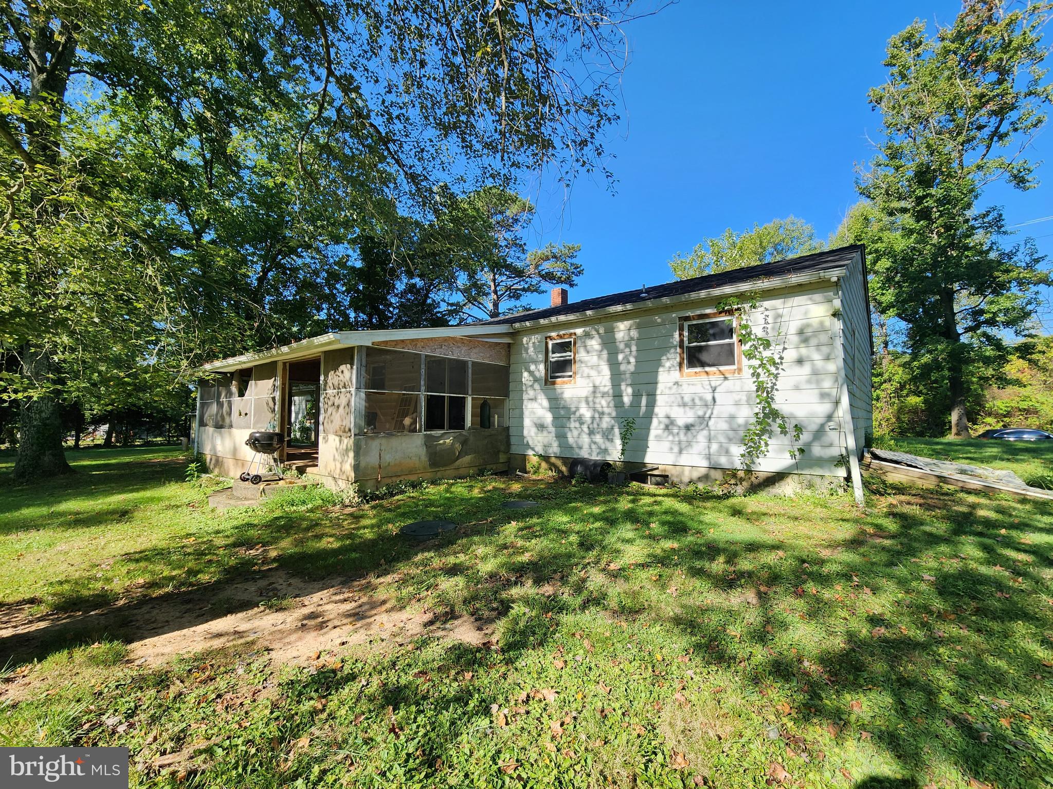 2616 Old Elk Neck Road Elkton, MD 21921 - Photo 13 of 25 a backyard of a house with table and chairs plants and large tree