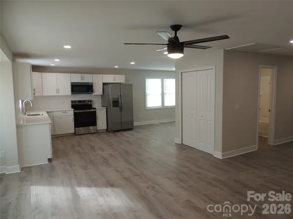 a view of a kitchen with a sink and a refrigerator