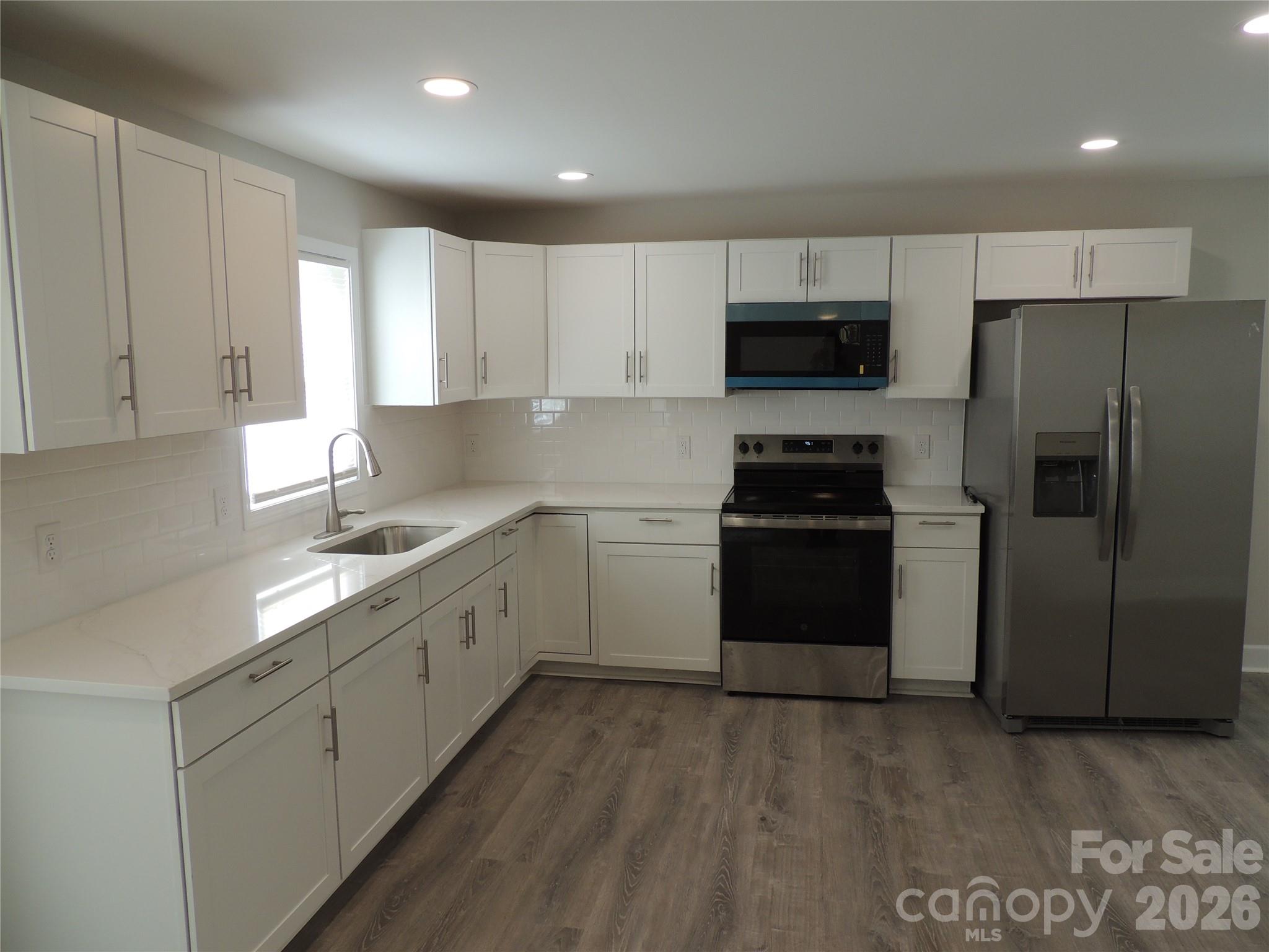 146 Loomis Street Chester, SC 29706 - Photo 3 of 12 a kitchen with a sink a stove a refrigerator and cabinets