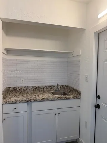 a view of sink and cabinets