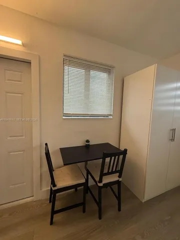 a view of a room that has a wooden bench and chair