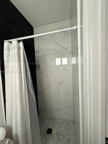 a view of backyard with wooden fence