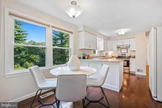 a dining room with furniture a window and wooden floor