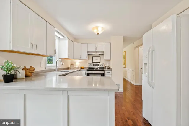 a kitchen with refrigerator and cabinets