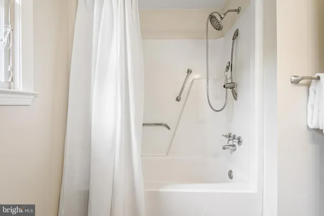 a bathroom with a bath tub and shower