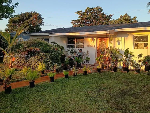 a front view of house with a garden