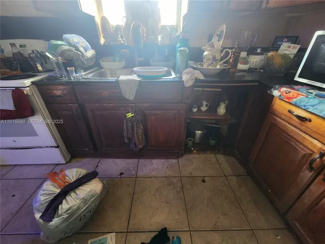 a room with water heater and wooden cabinets