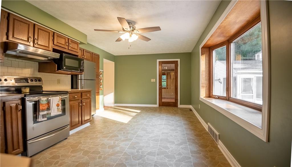 625 Stateline Road Bessemer, PA 16112 - Photo 7 of 19 a view of a kitchen with stainless steel appliances granite countertop a stove top oven