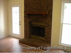 3327 Arrowhead Road Spring Lake, NC 28390 - Photo 6 of 17 a view of an empty room with wooden floor and a window