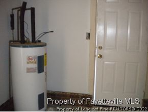 3327 Arrowhead Road Spring Lake, NC 28390 - Photo 9 of 17 a view of a hallway with wooden floor