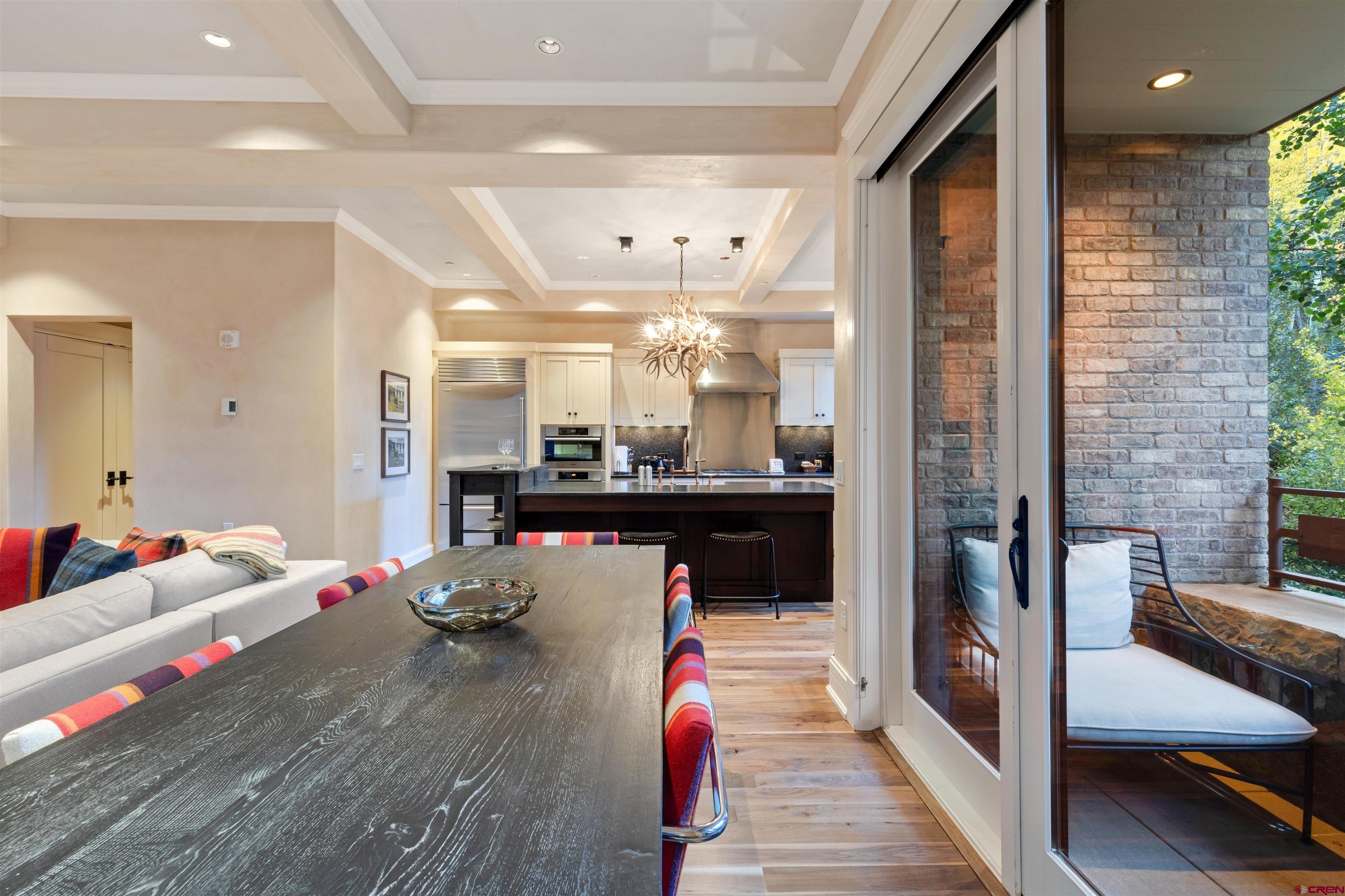 398 South Davis Street, Unit SW 201 Telluride, CO 81435 - Photo 11 of 23 a living room with kitchen furniture and a wooden floor