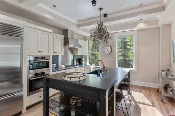 a kitchen with a table chairs stove and microwave