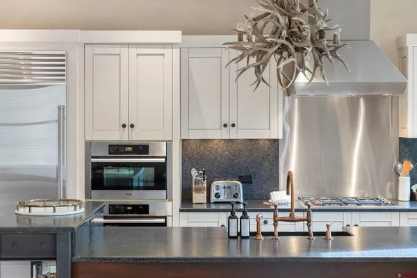 a kitchen with a stove a microwave and cabinets