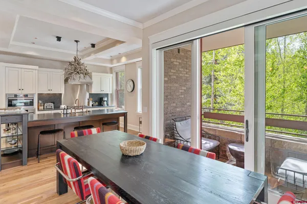 a living room with kitchen island granite countertop furniture and a floor to ceiling window