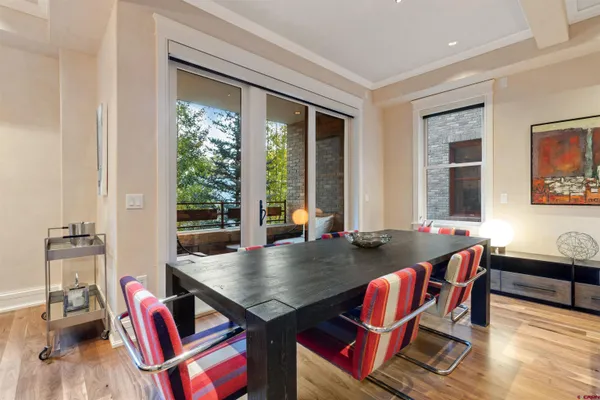 a living room with kitchen furniture and a wooden floor