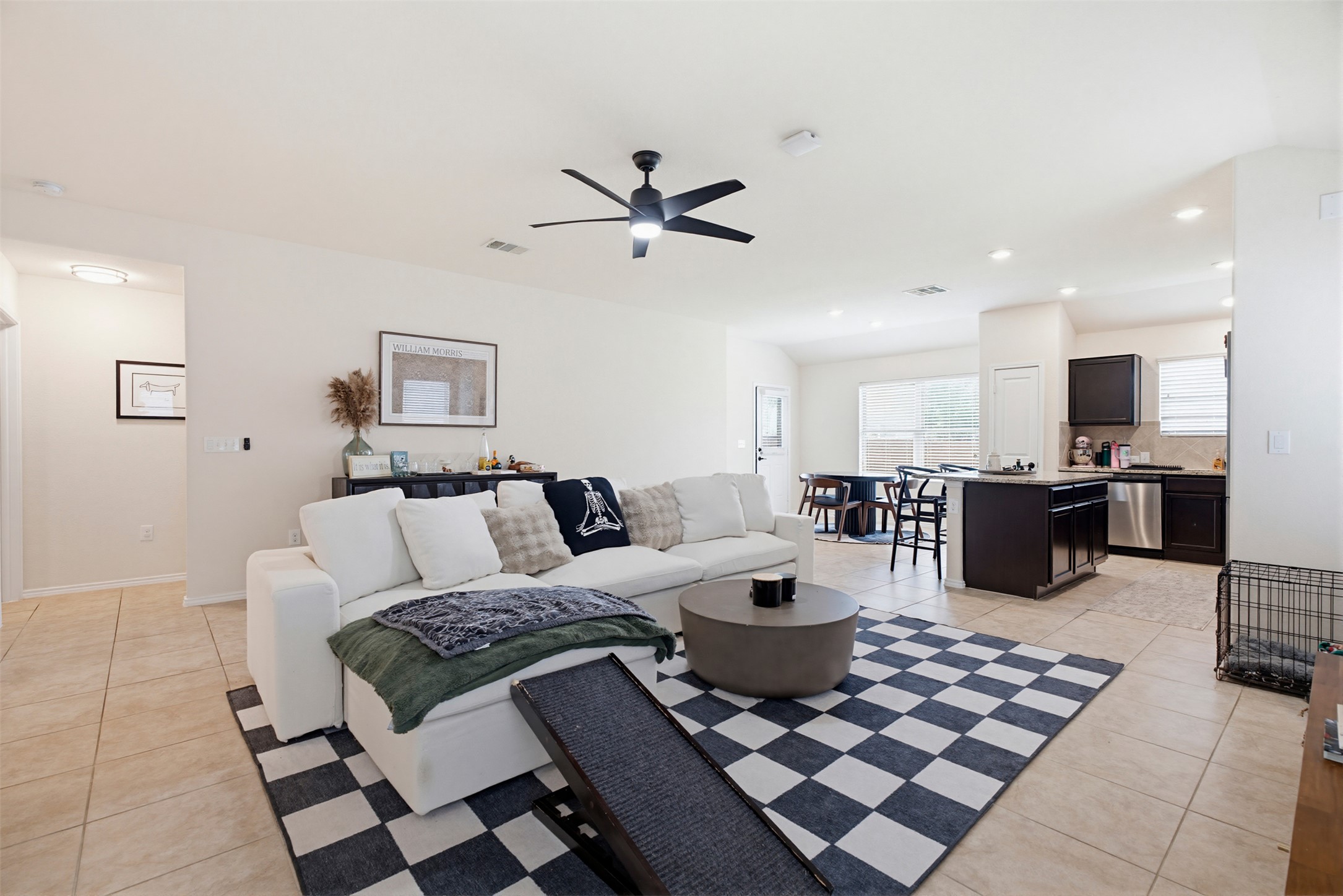 5705 Southerner Way Austin, TX 78747 - Photo 22 of 22 An open concept floorplan seamlessly connects the well-lit living area to a modern kitchen and dining space.