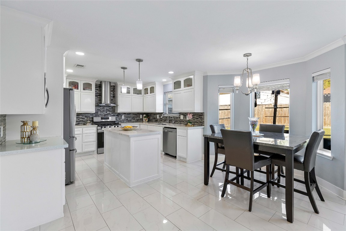 405 Mystic Trail Loop Houston, TX 77339 - Photo 17 of 44 a kitchen with a table chairs refrigerator and cabinets