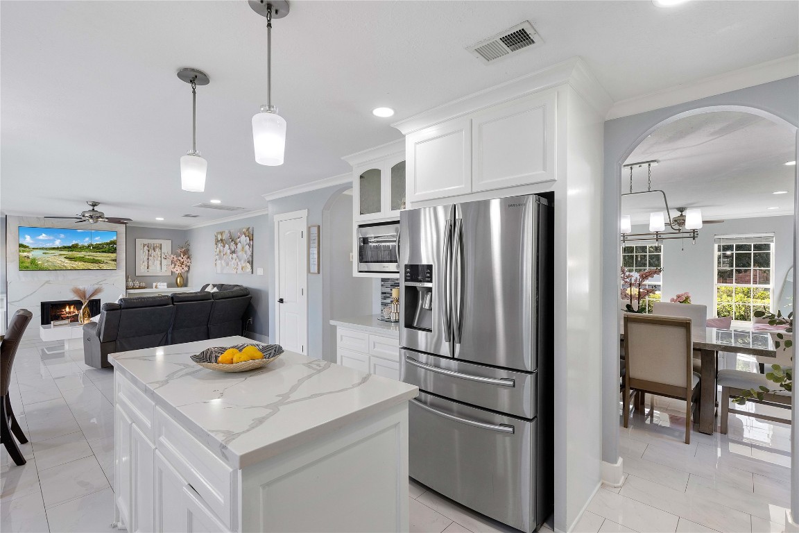 405 Mystic Trail Loop Houston, TX 77339 - Photo 19 of 44 a kitchen with stainless steel appliances a table chairs and refrigerator