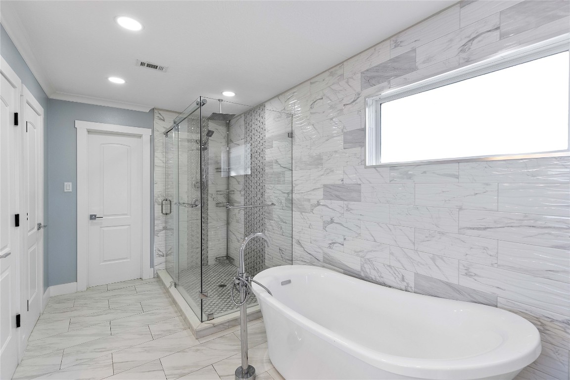 405 Mystic Trail Loop Houston, TX 77339 - Photo 24 of 44 a bathroom with a bathtub and a shower