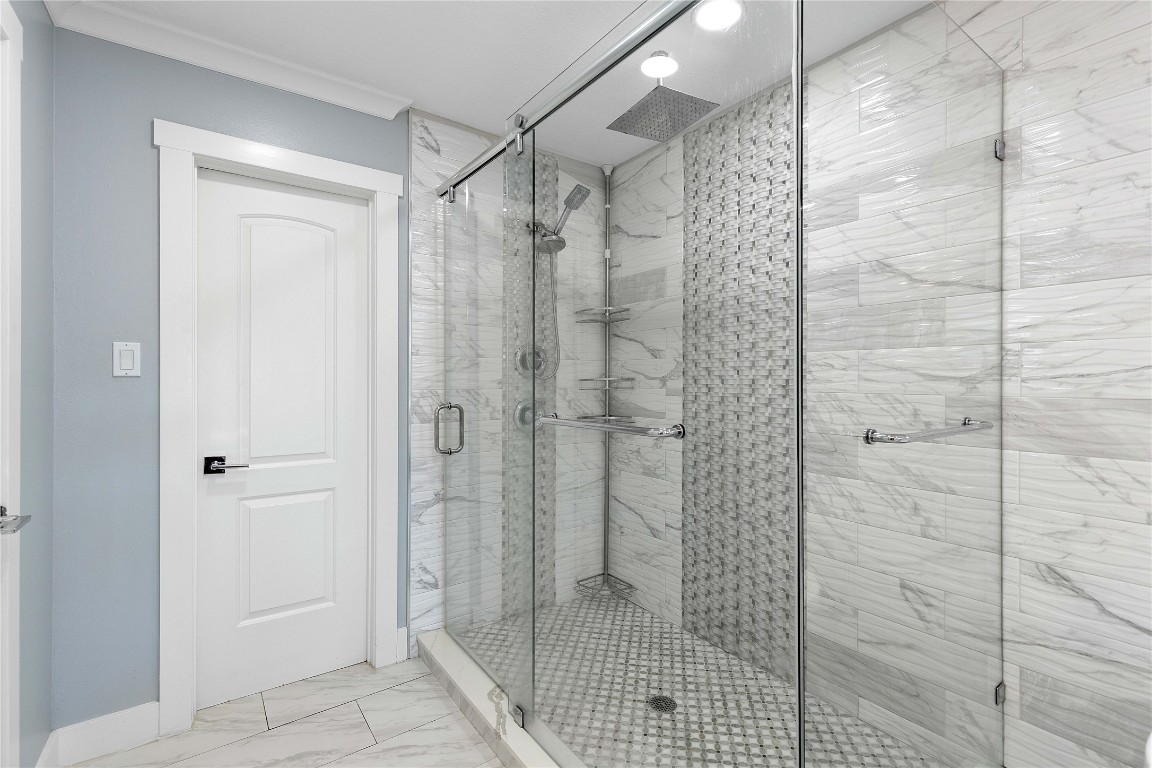 405 Mystic Trail Loop Houston, TX 77339 - Photo 26 of 44 a bathroom with a shower and a glass door