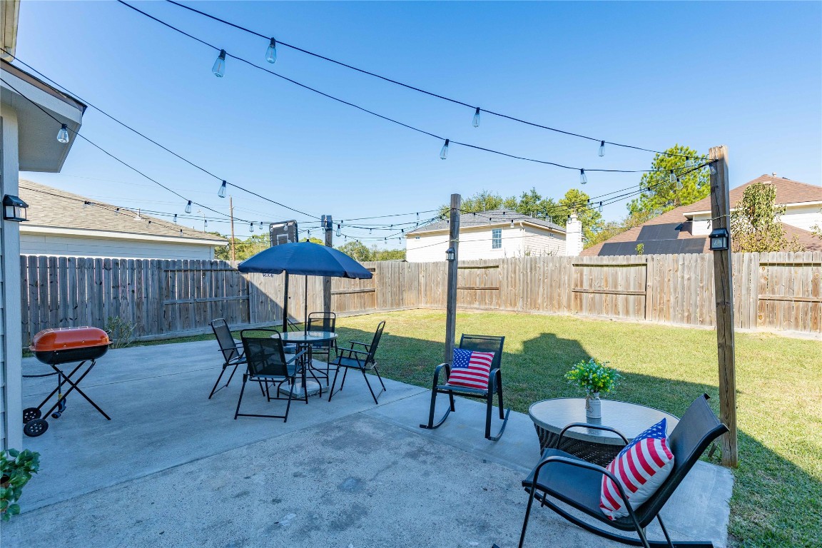 405 Mystic Trail Loop Houston, TX 77339 - Photo 37 of 44 a view of a patio with table and chairs potted plants with wooden fence