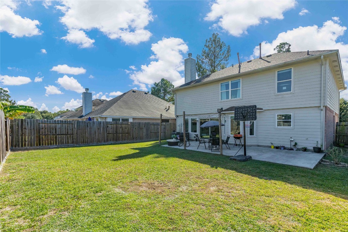 405 Mystic Trail Loop Houston, TX 77339 - Photo 39 of 44 a view of a house with a yard and table and chairs