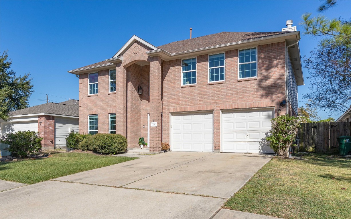 405 Mystic Trail Loop Houston, TX 77339 - Photo 42 of 44 a front view of a house with a yard and garage