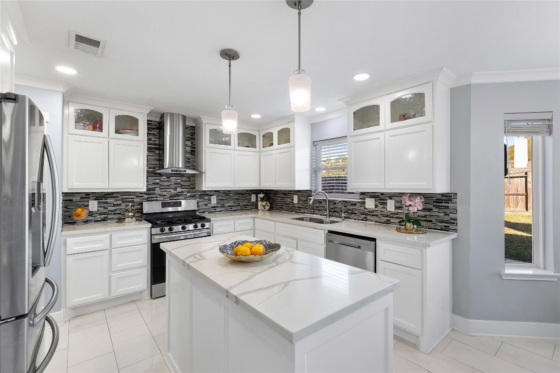 405 Mystic Trail Loop Houston, TX 77339 - Photo 10 of 44 a kitchen with a stove a sink and a refrigerator