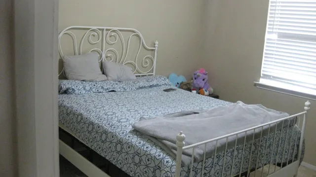 a bedroom with a bed and window