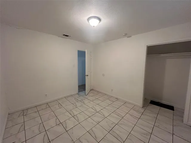 a white toilet sitting next to a bath tub and a shower