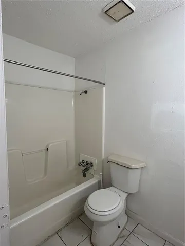 a bathroom with a granite countertop sink a toilet and a mirror