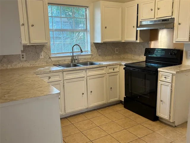 a kitchen with a sink and cabinets