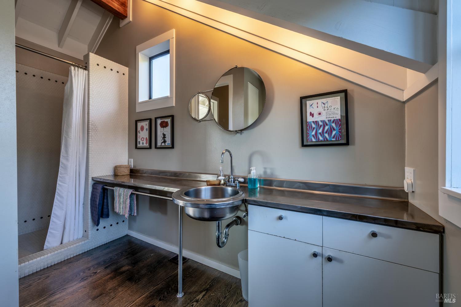 36690 Mariners Drive The Sea Ranch, CA 95497 - Photo 20 of 73 Primary bathroom with stainless steel sink and counter, tiles stall shower and beautiful wood floors.