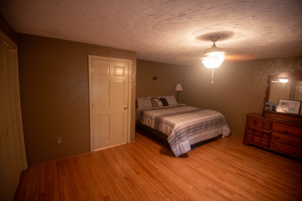239 North Brookfield Road Barre, MA 01005 - Photo 38 of 42 a bedroom with a bed and wooden floor