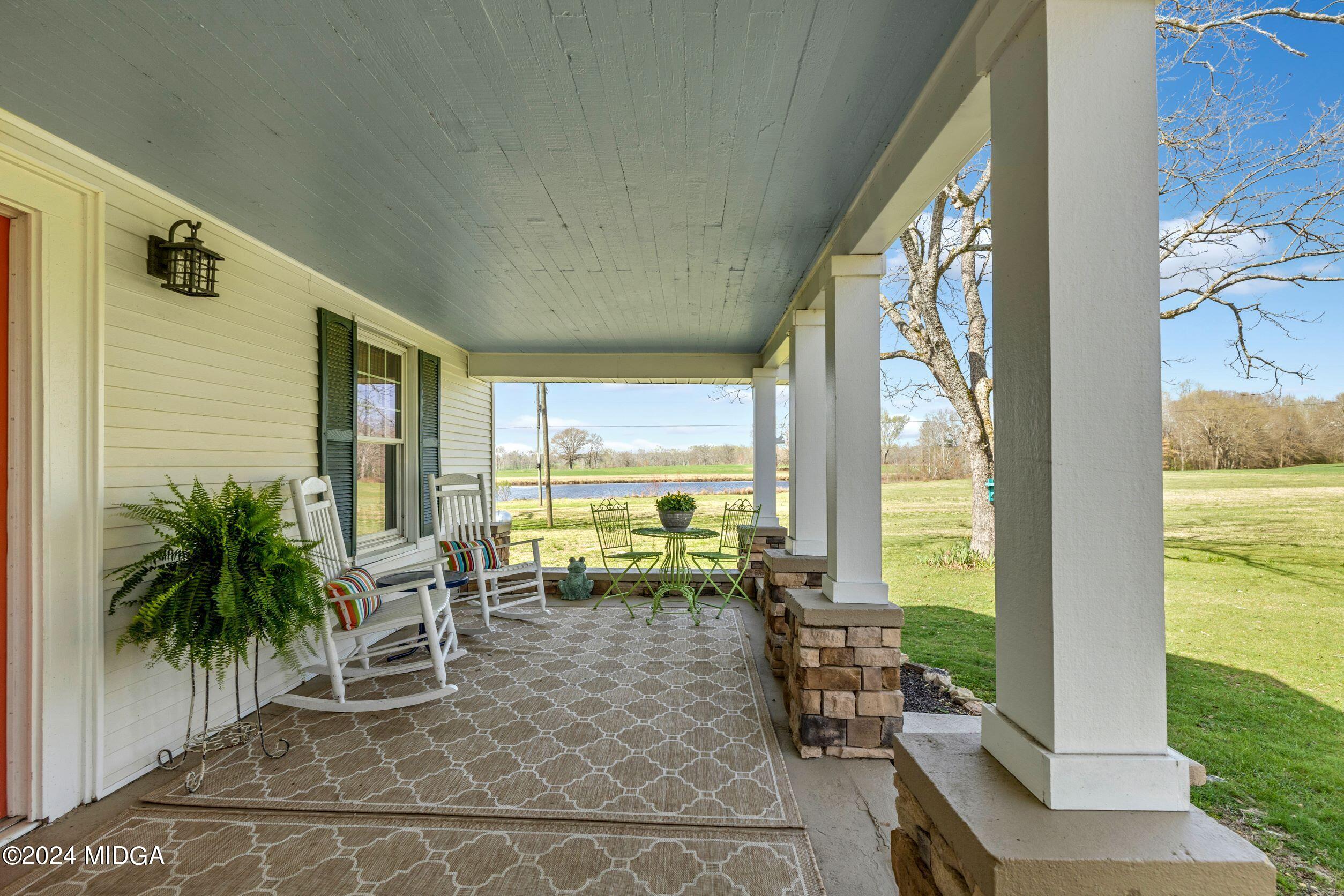 475 Brent Road Barnesville, GA 30204 - Photo 107 of 132 a living room with furniture and floor to ceiling windows