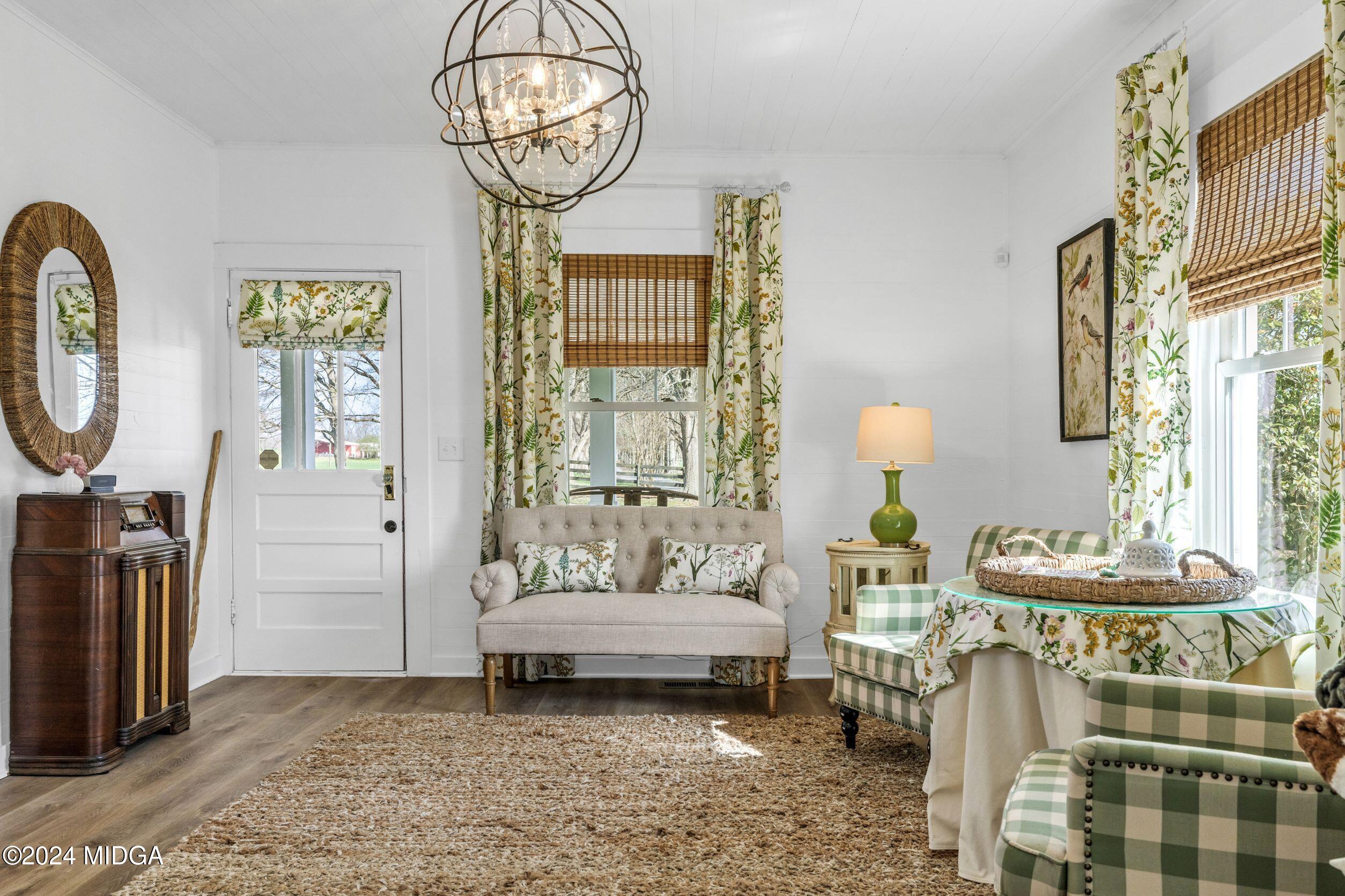 475 Brent Road Barnesville, GA 30204 - Photo 111 of 132 a living room with furniture a chandelier and a table