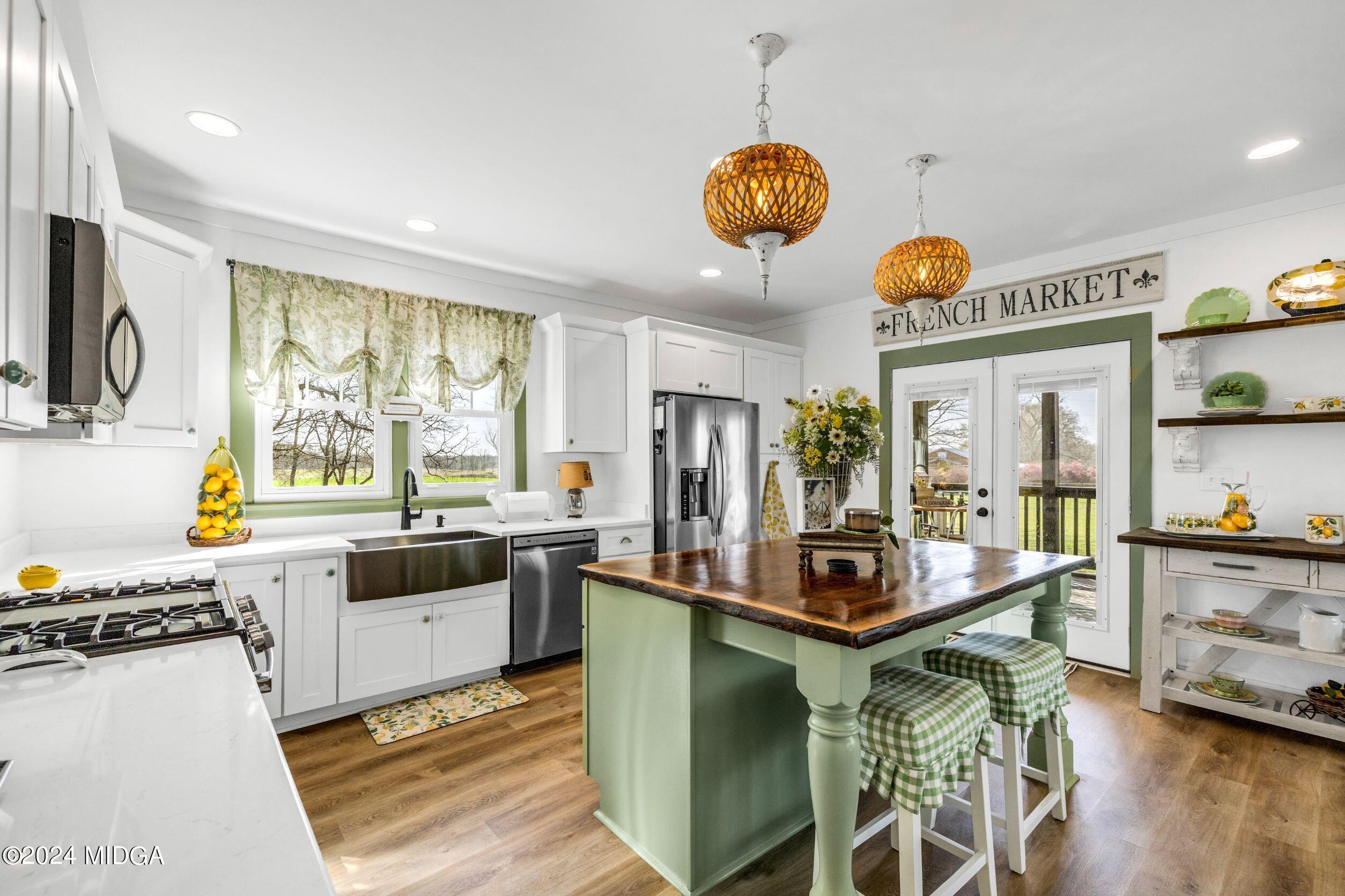 475 Brent Road Barnesville, GA 30204 - Photo 113 of 132 a kitchen with stainless steel appliances granite countertop a stove and a sink