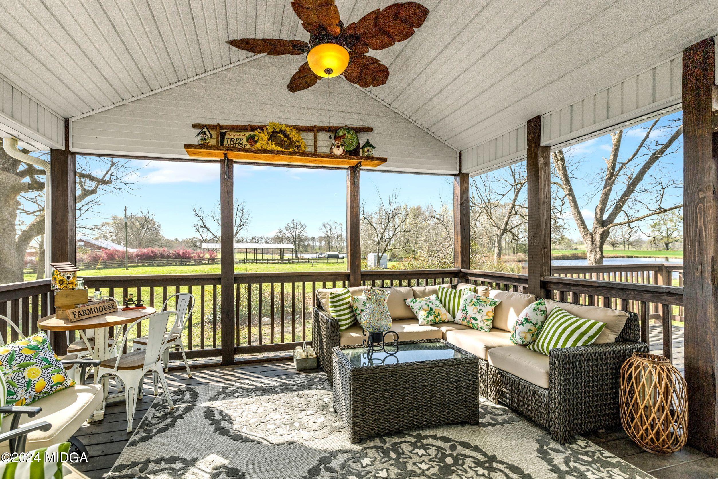 475 Brent Road Barnesville, GA 30204 - Photo 128 of 132 a living room with furniture and a floor to ceiling window