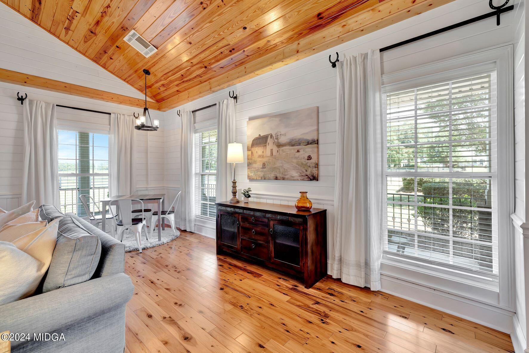 475 Brent Road Barnesville, GA 30204 - Photo 63 of 132 a living room with furniture a large window and wooden floor
