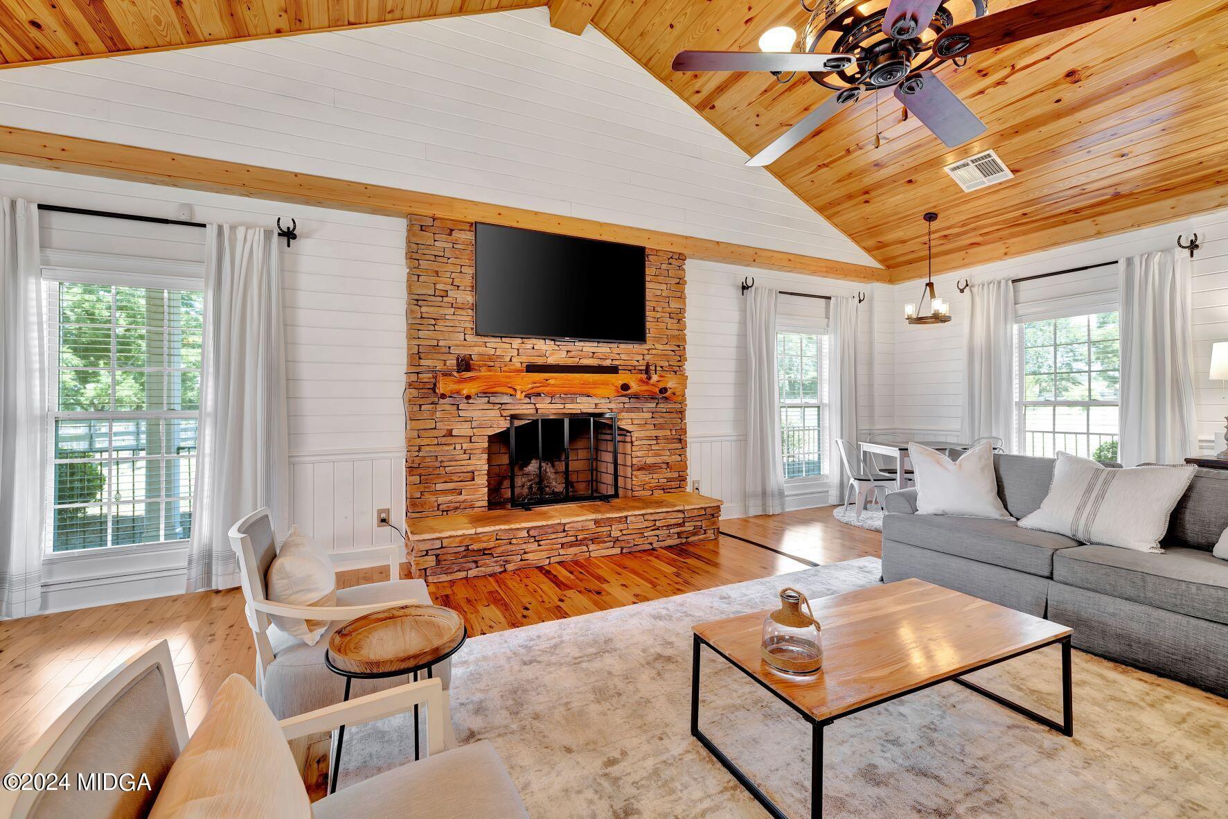 475 Brent Road Barnesville, GA 30204 - Photo 68 of 132 a living room with furniture a flat screen tv and a fireplace