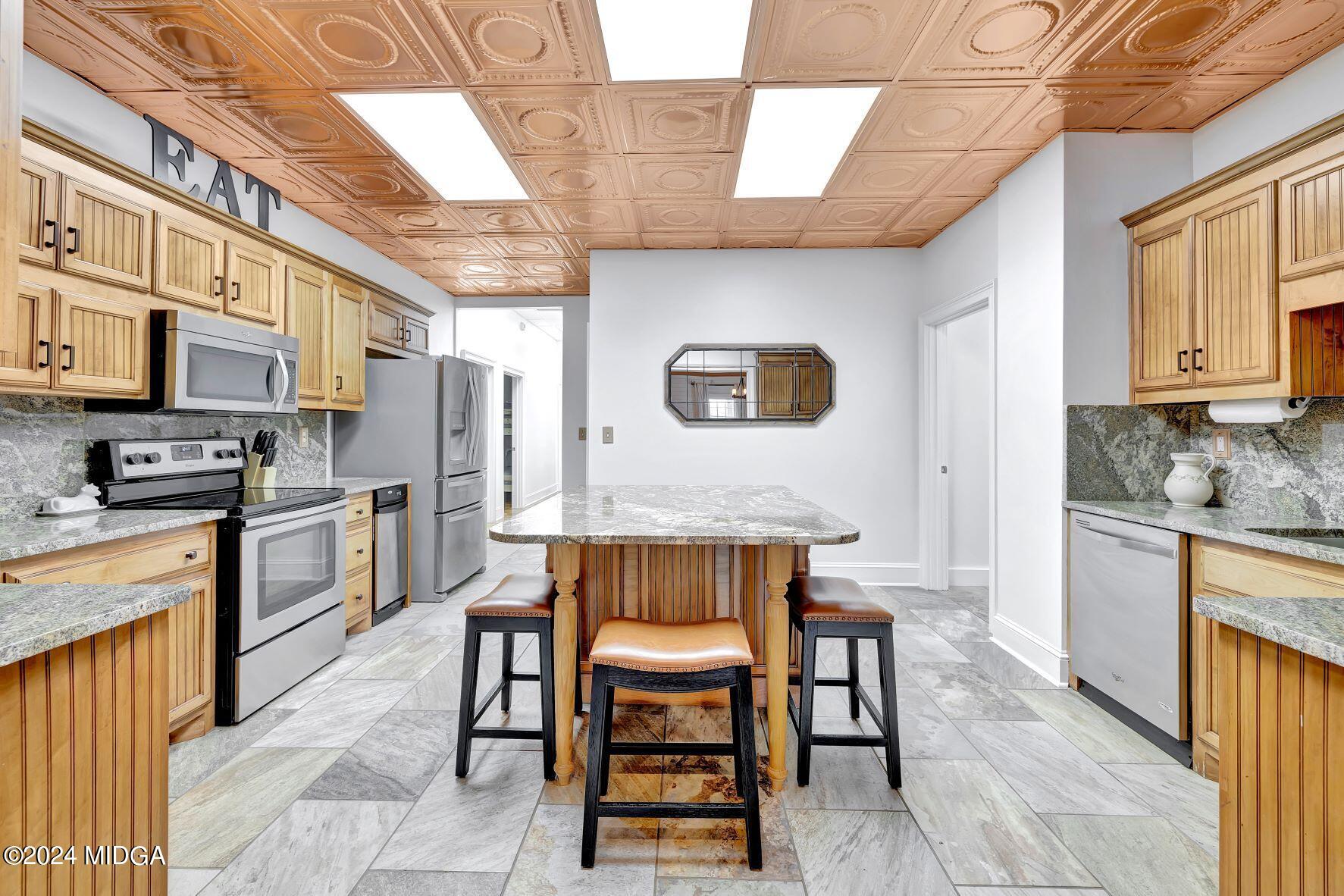 475 Brent Road Barnesville, GA 30204 - Photo 72 of 132 a kitchen with granite countertop a stove a sink and a refrigerator